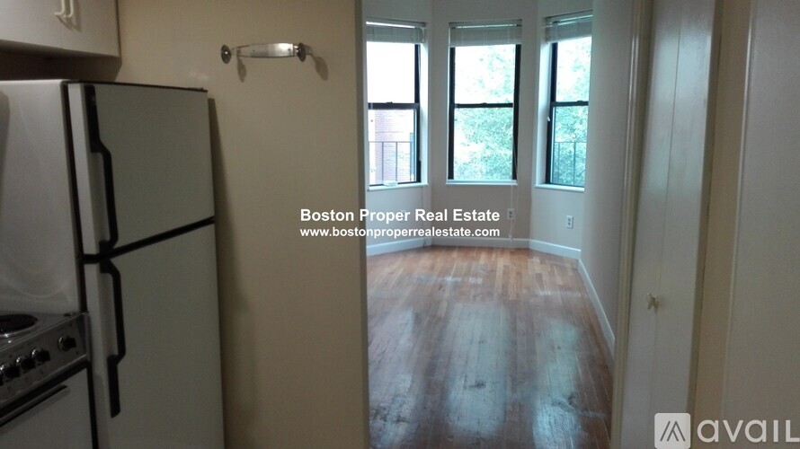 A kitchen with a refrigerator and stove is available for rent.