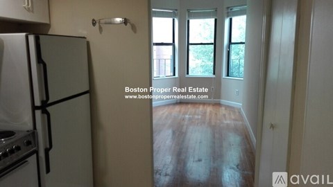 A kitchen with a refrigerator and stove is available for rent.