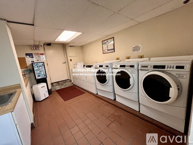 A row of washing machines in a public laundromat.