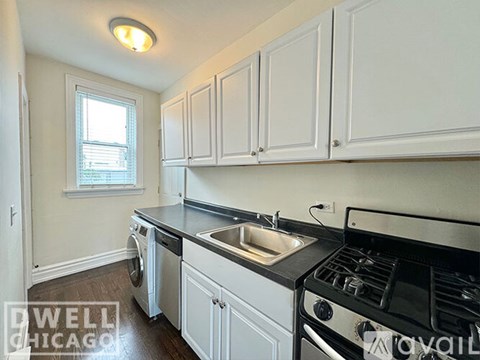 A kitchen with white cabinets and a black stove top.
