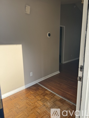 A room with a wooden floor and a door.