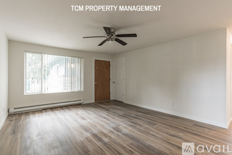 A room with a ceiling fan and wooden flooring is available for rent.