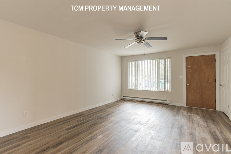 A room with a ceiling fan and wooden flooring is available for rent.
