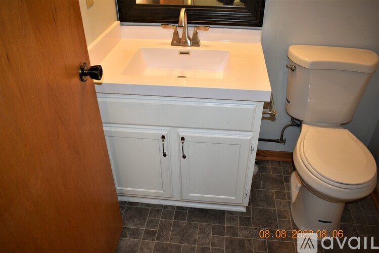 A bathroom with a white sink and toilet.