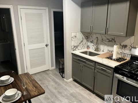 A kitchen with a wooden table and a white door.