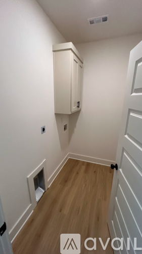 A white wall with a cabinet and a door.