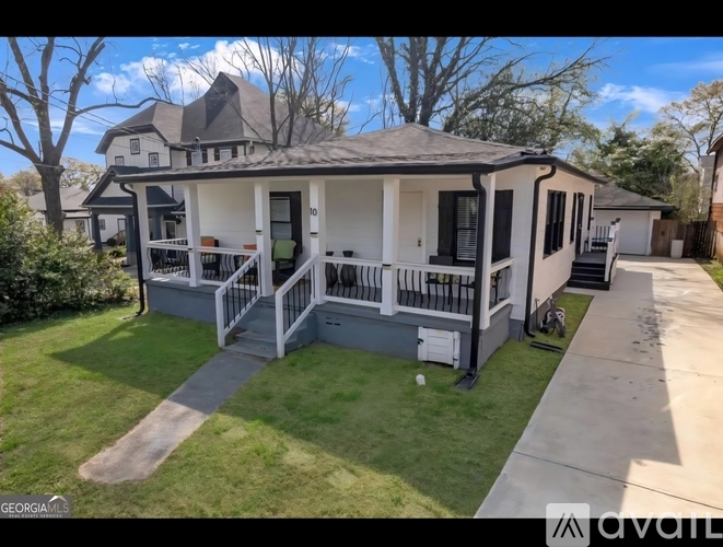 A house with a porch and a covered patio is for sale.