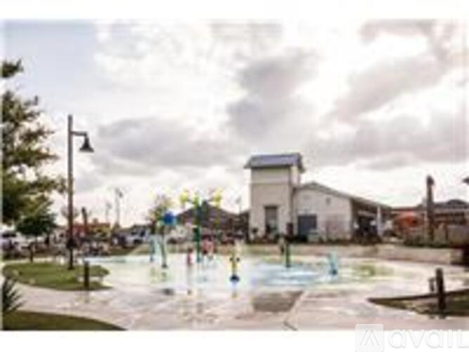 A playground with a water feature in the middle of a park.