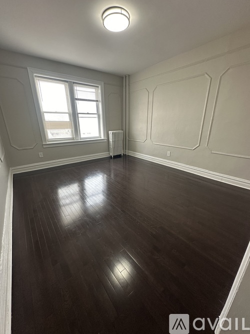 A room with wooden floors and a window.