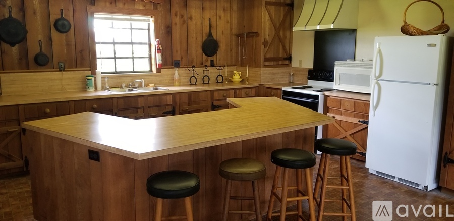 A kitchen with wooden cabinets and a white fridge.