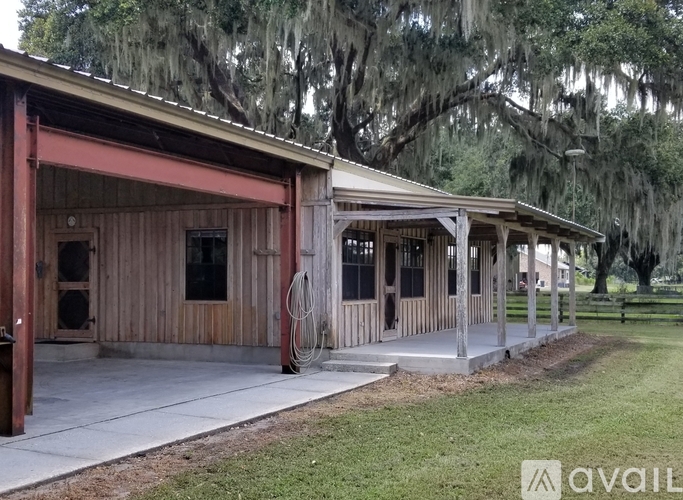 A wooden building with a porch and a hanging light fixture.
