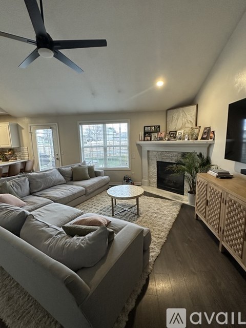 A living room with a grey sofa and a white coffee table.