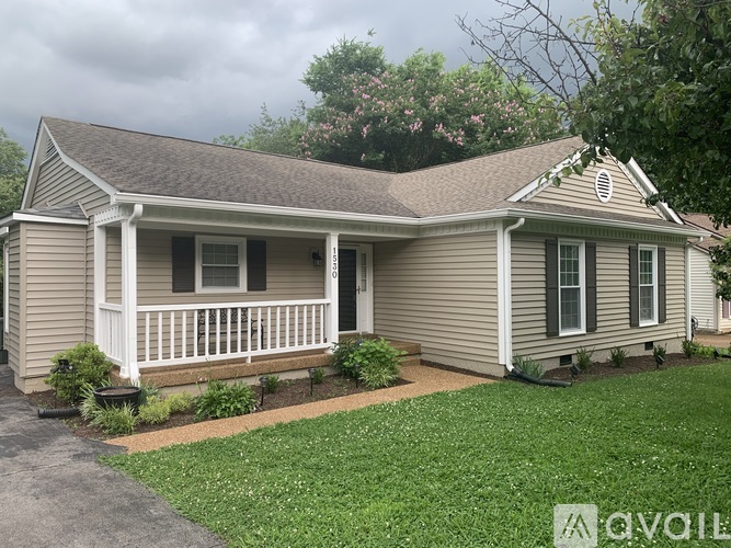 A house with a porch and a front yard.