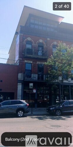 A building with a balcony on the second floor.