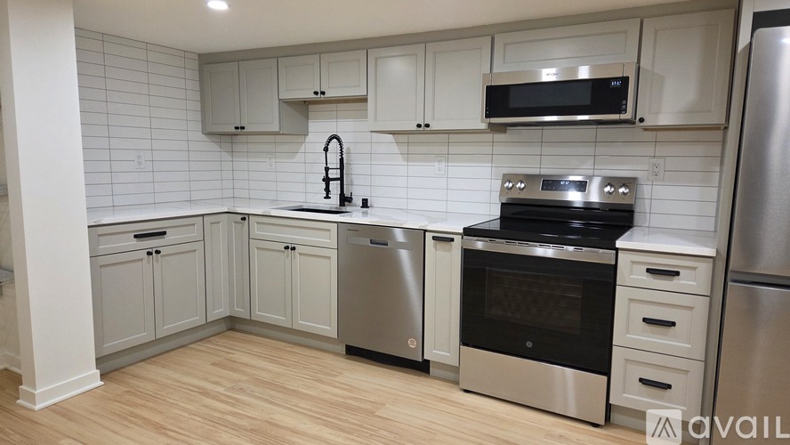 A kitchen with white cabinets and stainless steel appliances.