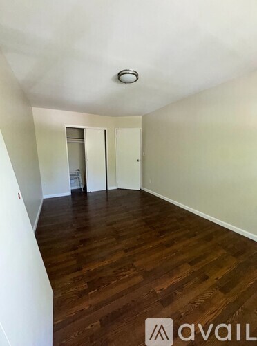 A room with wooden floors and white walls.