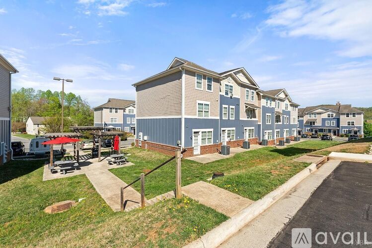 A row of houses with a grassy area in front.