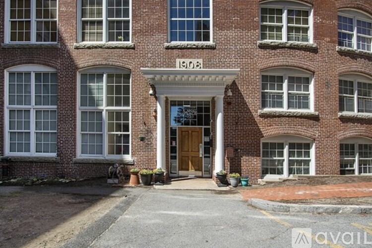 A red brick building with the number 1908 on the front.