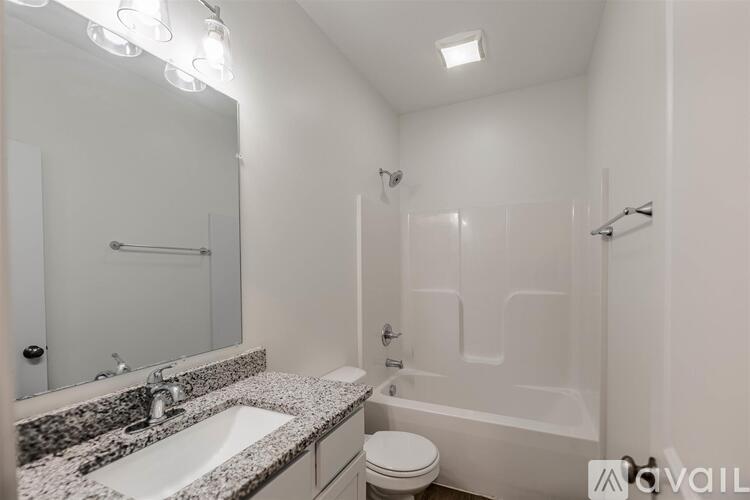 A bathroom with a sink, toilet, and bathtub.
