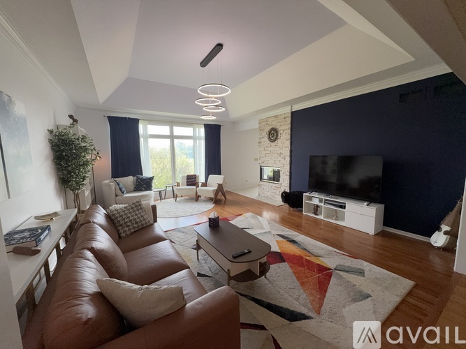 A living room with a brown leather couch and a white coffee table.