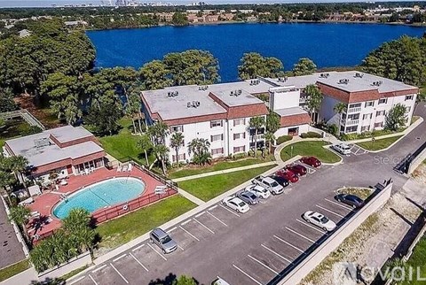 A large building with a pool in front of it.