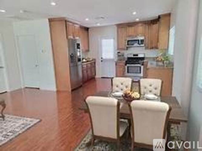 A kitchen with a dining table set for two.