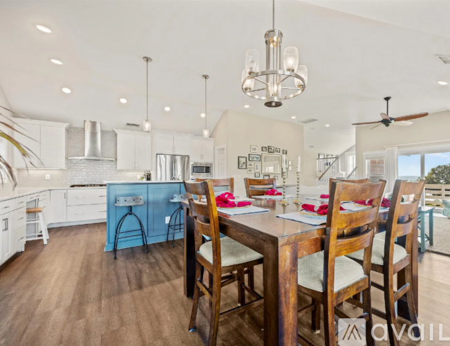 A modern kitchen with a dining table set for four.