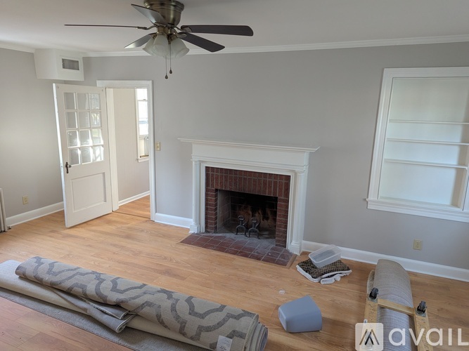 A room with a fireplace and a ceiling fan.