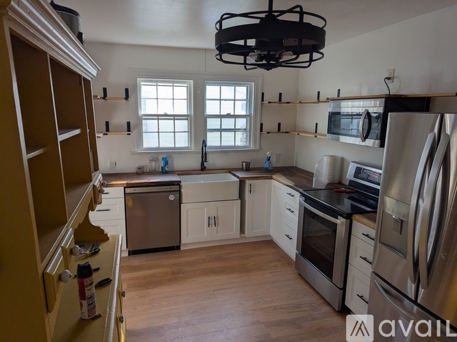 A kitchen with wooden floors and stainless steel appliances.