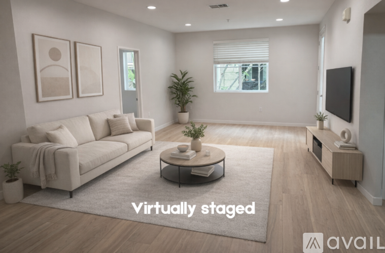 A living room with a couch, coffee table, and television.