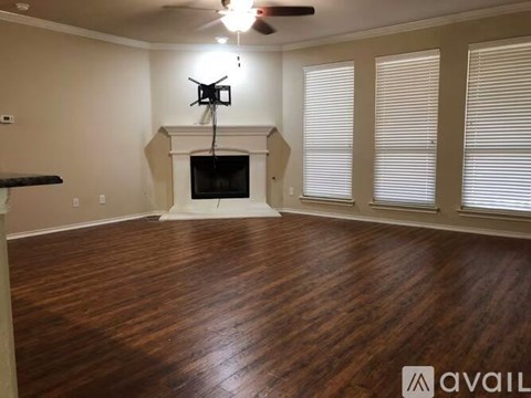 A living room with a fireplace and a television.