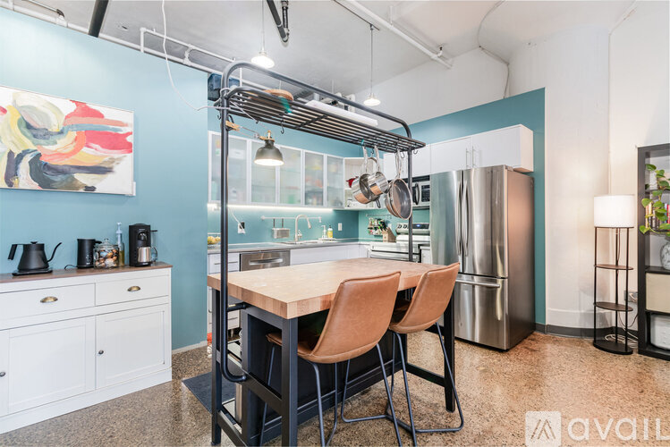 A kitchen with a table and chairs in the middle of it.