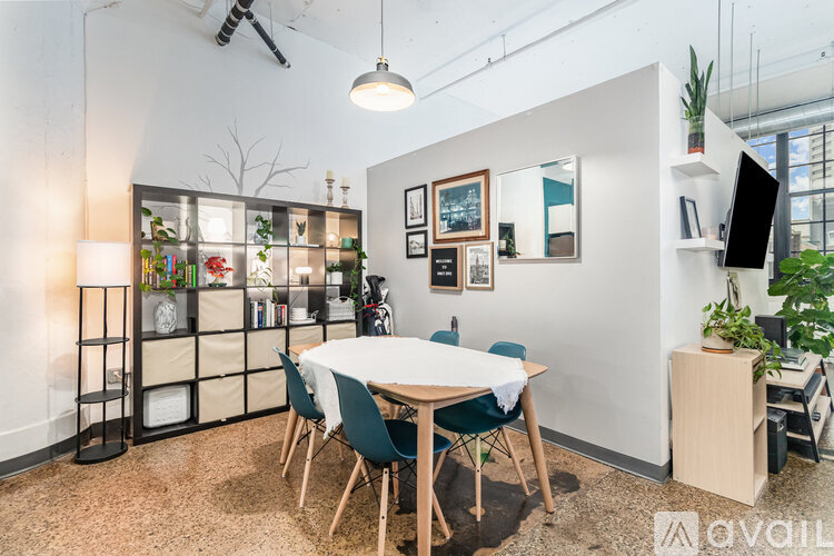 A conference room with a white table and chairs.