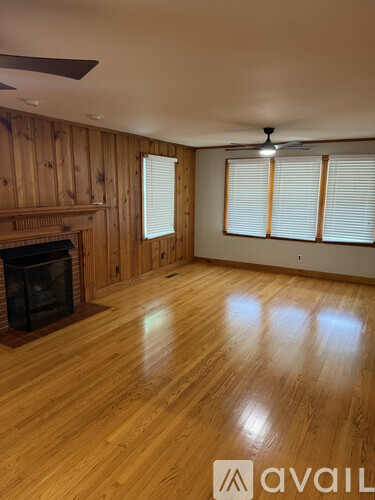 A room with wooden floors and a fireplace.