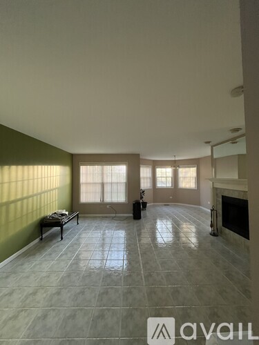 A living room with a fireplace and a large window.
