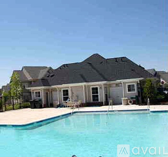 A house with a pool in front of it.
