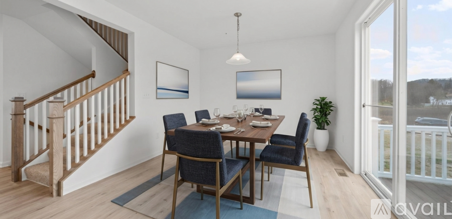A dining room with a wooden table and chairs.