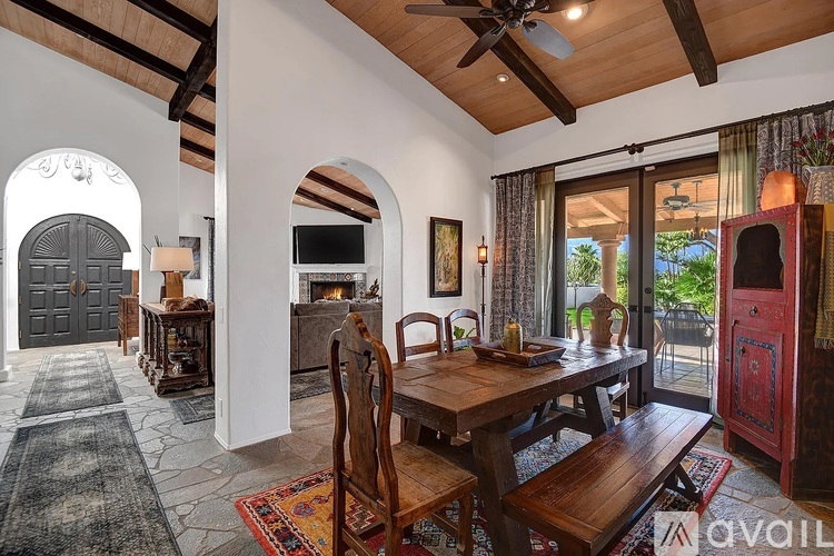 A dining room with a wooden table and chairs.