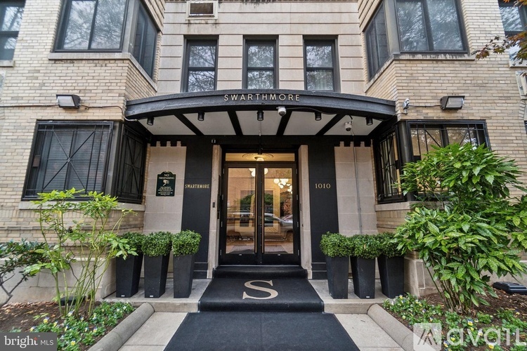 The entrance to a building with a black awning and a sign that reads "Swartmore.".