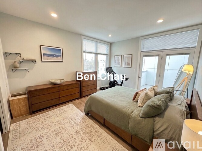 A bedroom with a bed, dresser, and window.