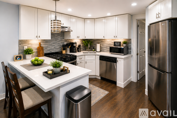 A modern kitchen with a white island and stainless steel appliances.
