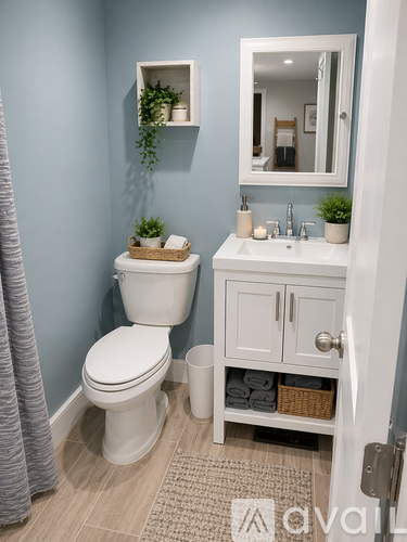 A white toilet sits in a bathroom with a blue wall.