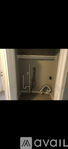 A white door with a handle and a white shelf above it.