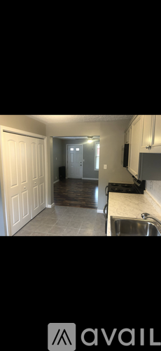 A kitchen with white cabinets and a sink.