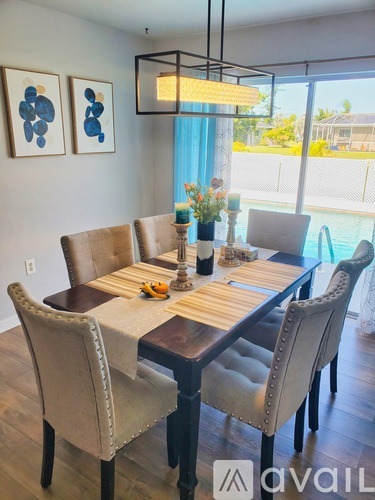 A dining room with a table set for six.