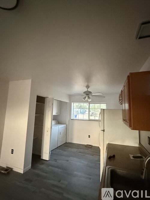 A room with a ceiling fan and a window.