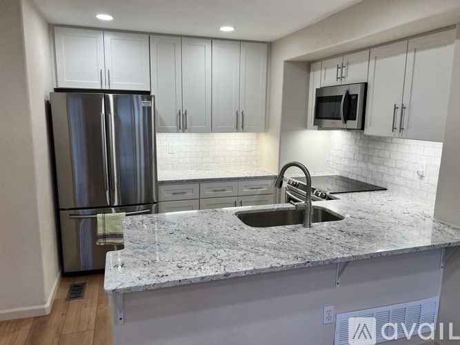 A kitchen with granite countertops and stainless steel appliances.