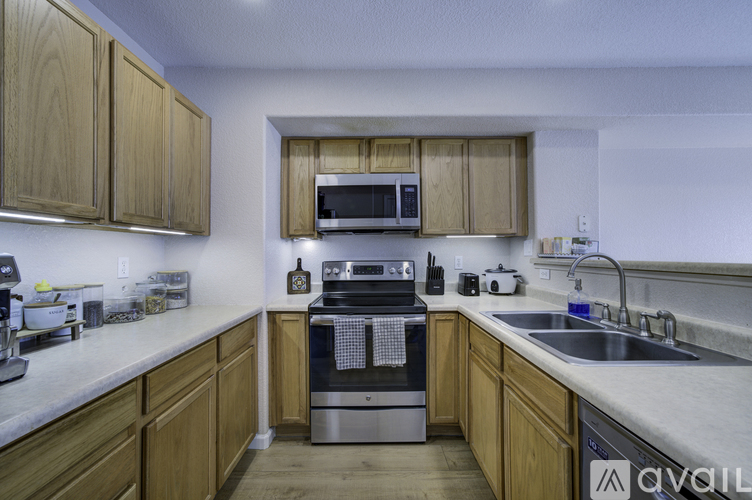 A kitchen with wooden cabinets and a stainless steel oven.