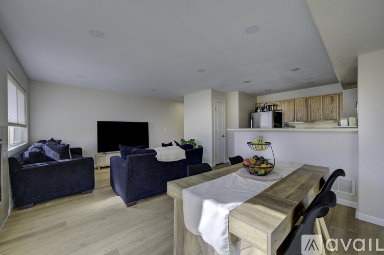 A living room with a grey couch and a wooden table.