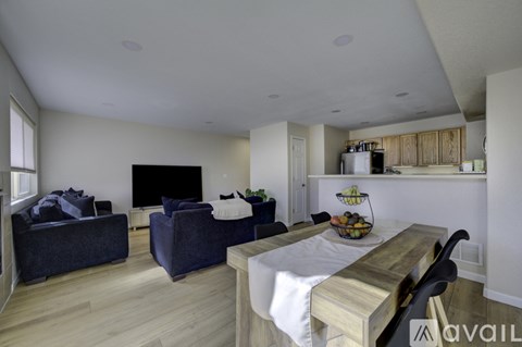 A living room with a grey couch and a wooden table.